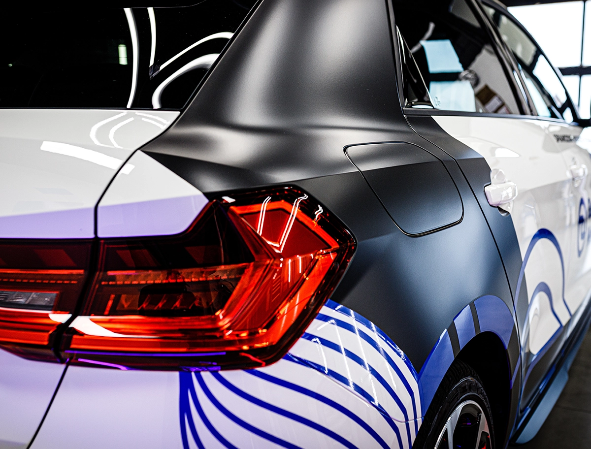 Professional vehicle wrap installation on a car